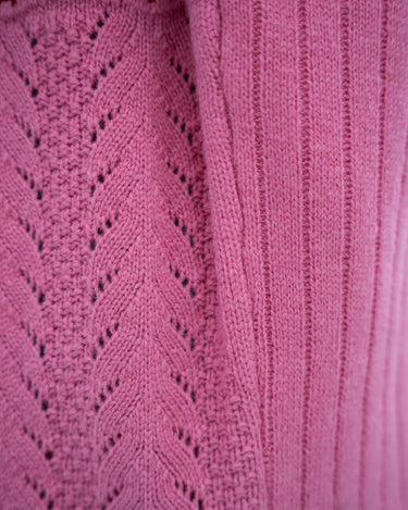Nærbilde av detaljene på ANN half zip i rosa fra siden.