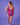 Bilde tatt av den mønstrede rosa badedrakten fra baksiden. Personen står foran en lilla bakgrunn.